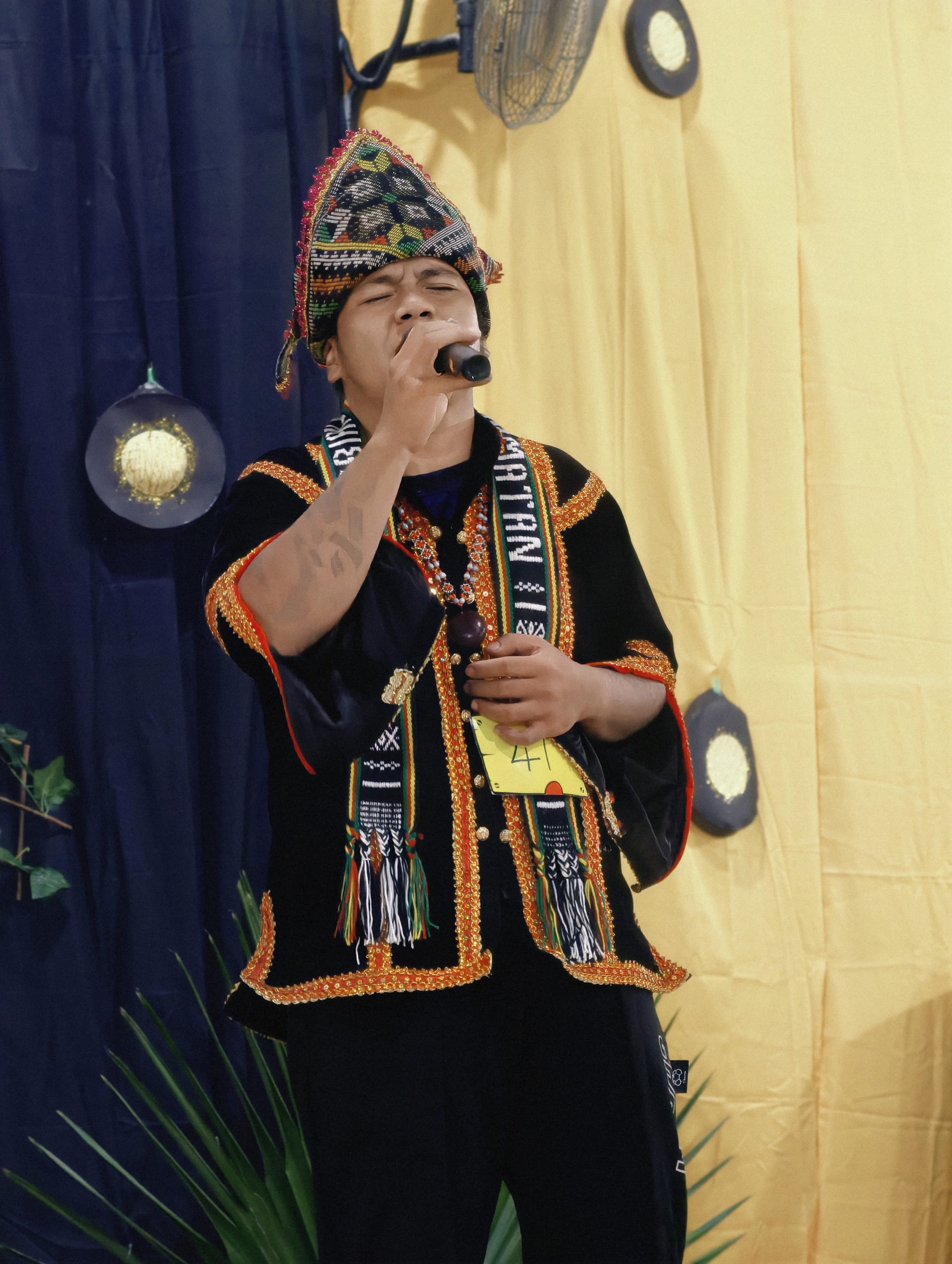Mufeiz performing in traditional Sabah attire